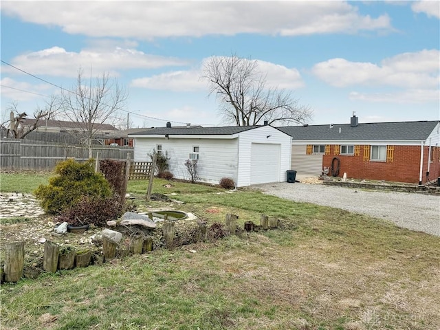 rear view of property with a lawn and a garage