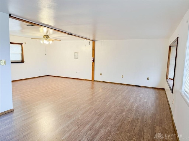 empty room with hardwood / wood-style floors and ceiling fan