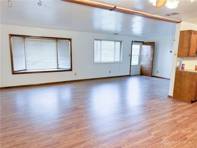 unfurnished living room with ceiling fan and light hardwood / wood-style flooring