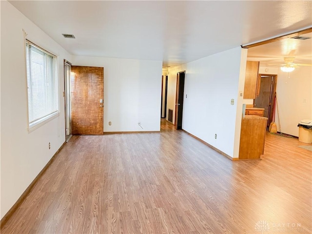 spare room featuring light wood-type flooring and ceiling fan