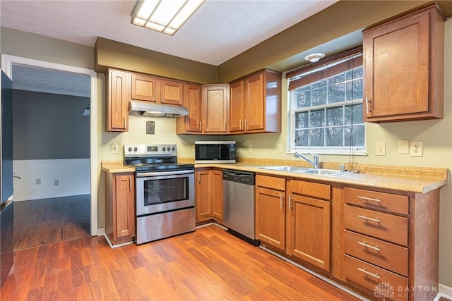 kitchen with dark hardwood / wood-style flooring, sink, and appliances with stainless steel finishes