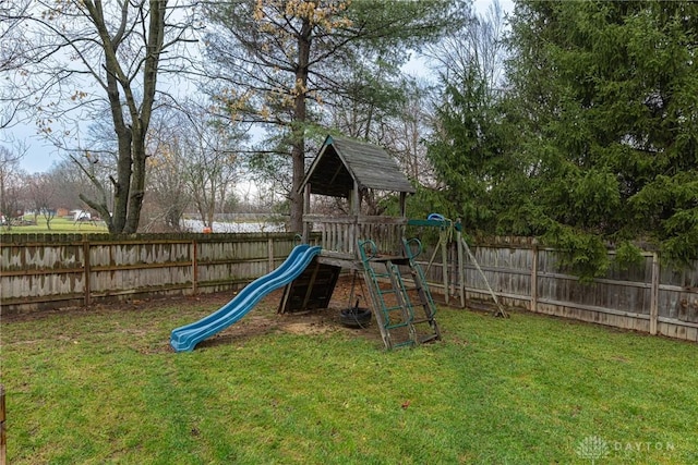 view of jungle gym with a yard and a fenced backyard