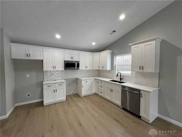 kitchen featuring sink, white cabinetry, and stainless steel appliances