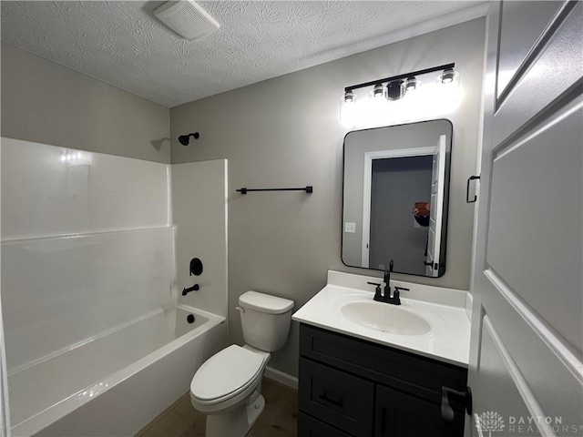 full bathroom featuring vanity,  shower combination, a textured ceiling, and toilet