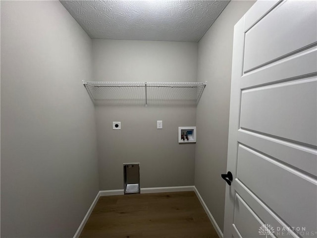 laundry room featuring electric dryer hookup, hardwood / wood-style flooring, a textured ceiling, and hookup for a washing machine