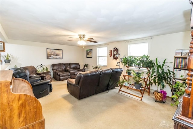 carpeted living room with ceiling fan