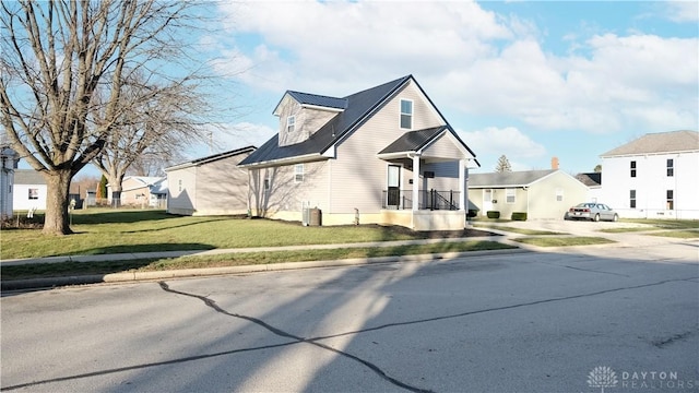 view of front of property with central AC unit and a front yard