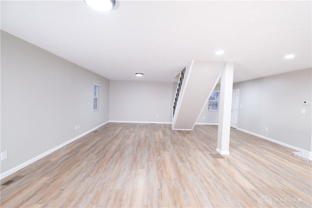 basement with light hardwood / wood-style floors