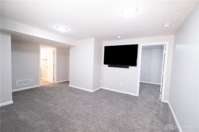 basement with carpet and a textured ceiling