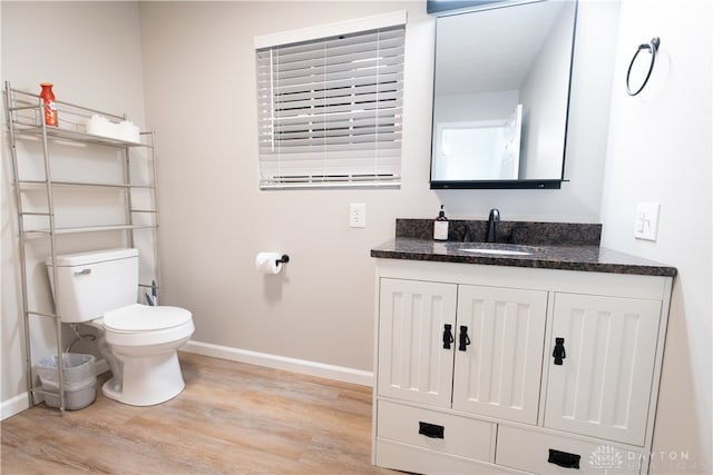 bathroom featuring hardwood / wood-style flooring, vanity, and toilet