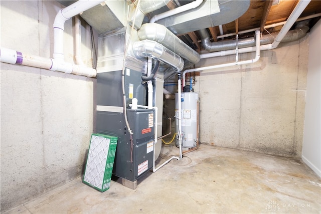 utility room with heating unit and gas water heater