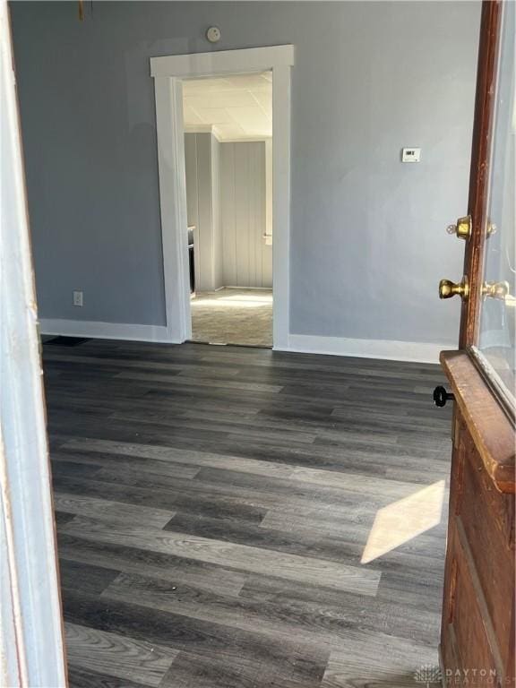 spare room with dark hardwood / wood-style floors