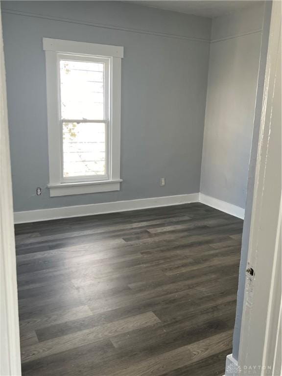 spare room featuring dark hardwood / wood-style floors