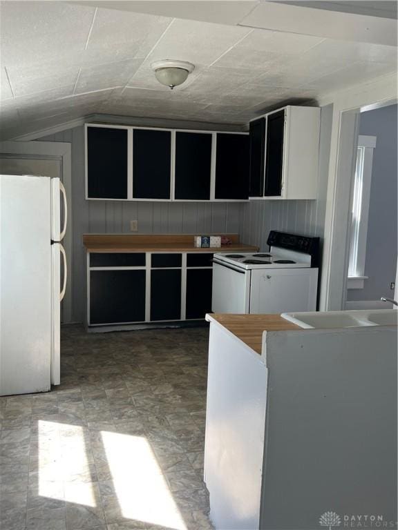 kitchen with lofted ceiling and white appliances