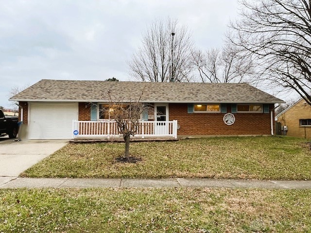 single story home with a garage and a front lawn