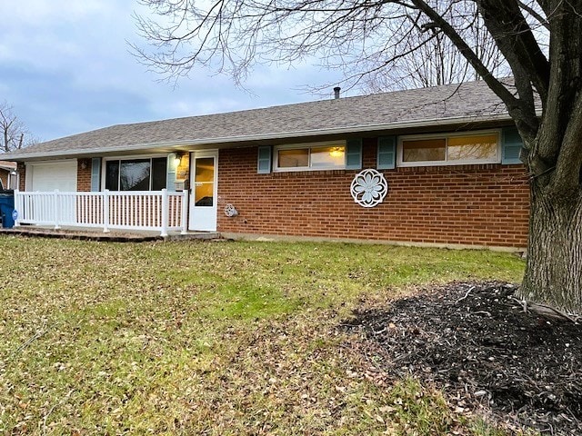 ranch-style house with a garage and a front yard