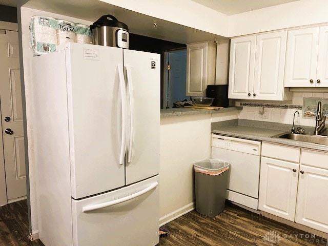 kitchen featuring white appliances, tasteful backsplash, dark wood-type flooring, and sink