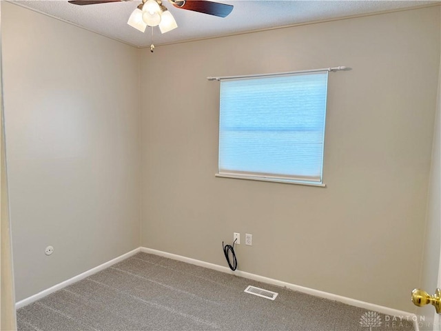 unfurnished room featuring ceiling fan and carpet floors