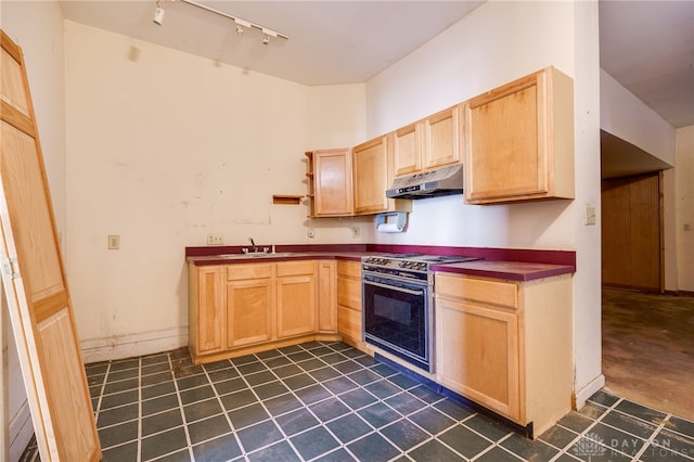 kitchen with stove, sink, light brown cabinetry, and track lighting