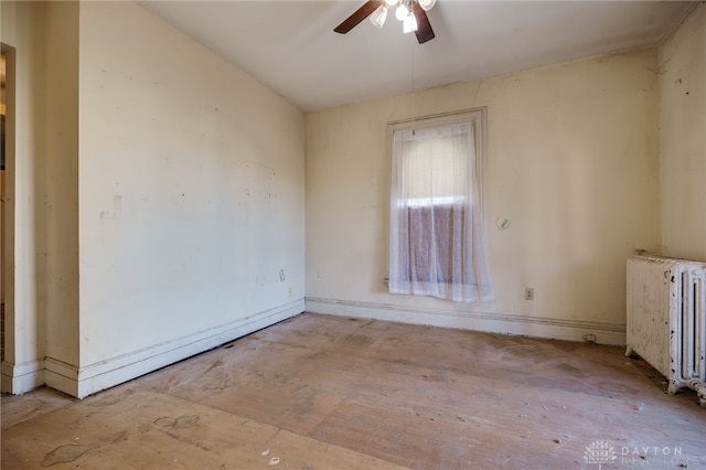 spare room featuring ceiling fan and radiator heating unit