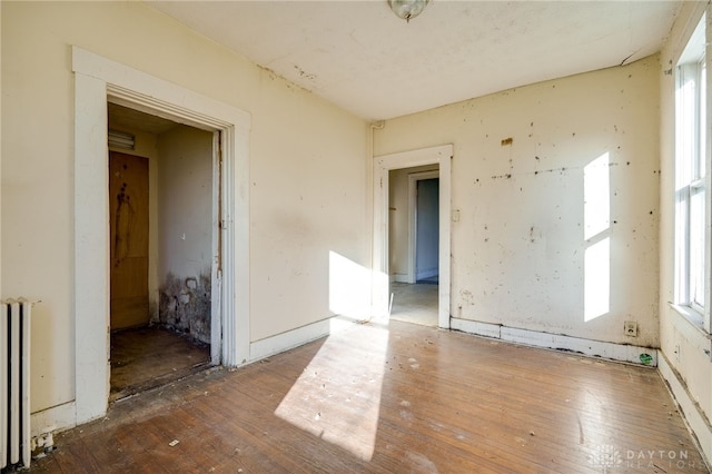 unfurnished room featuring radiator