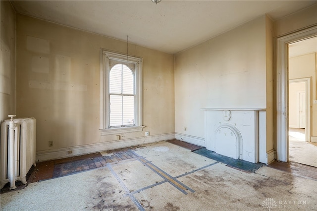 unfurnished room featuring radiator heating unit