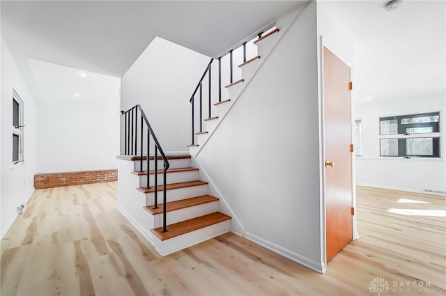 stairs with recessed lighting, visible vents, baseboards, and wood finished floors