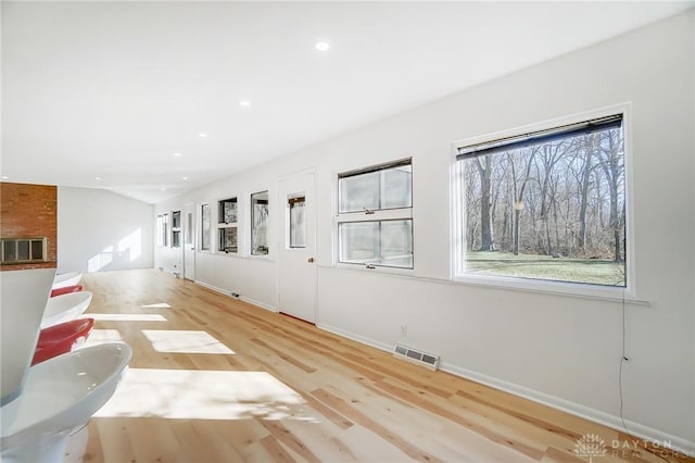interior space with visible vents, recessed lighting, plenty of natural light, and wood finished floors