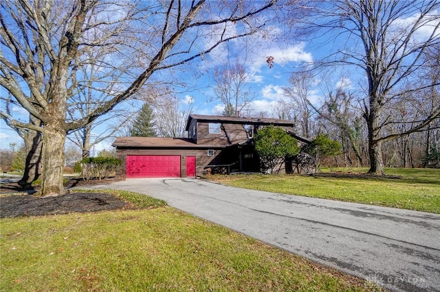 exterior space featuring an attached garage, a lawn, and aphalt driveway