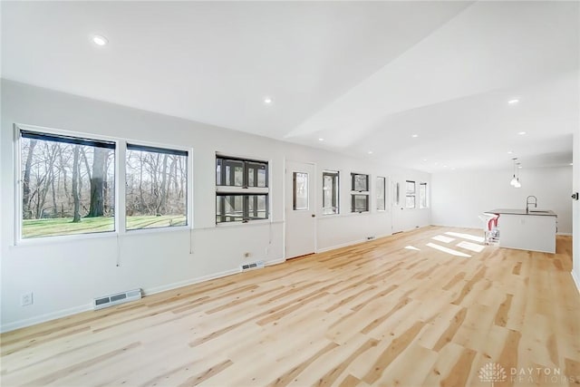 unfurnished living room featuring recessed lighting, visible vents, and light wood-style flooring