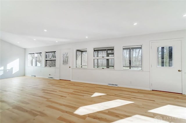 unfurnished living room featuring visible vents, baseboards, light wood finished floors, and recessed lighting