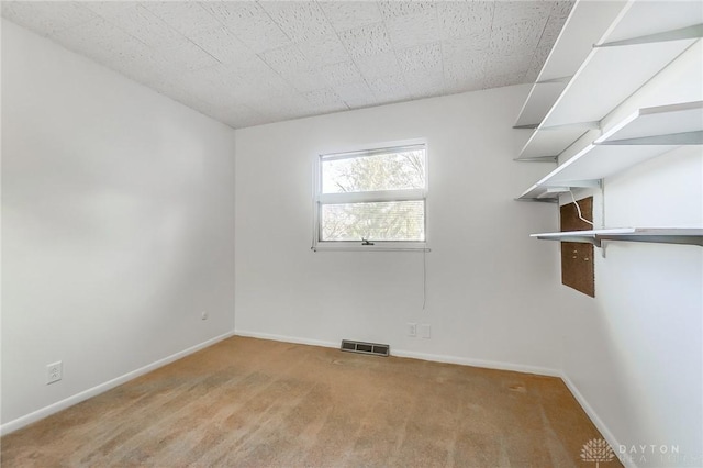 empty room with light carpet, baseboards, and visible vents