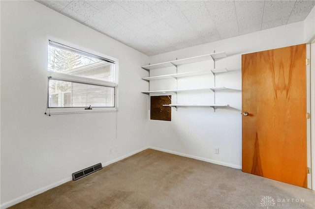walk in closet with visible vents and carpet floors