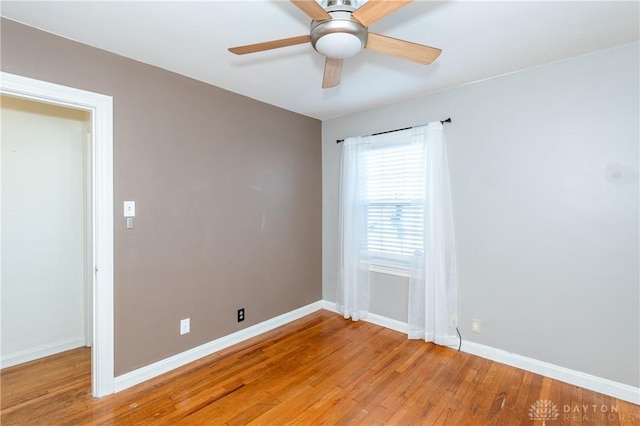 empty room with hardwood / wood-style flooring and ceiling fan