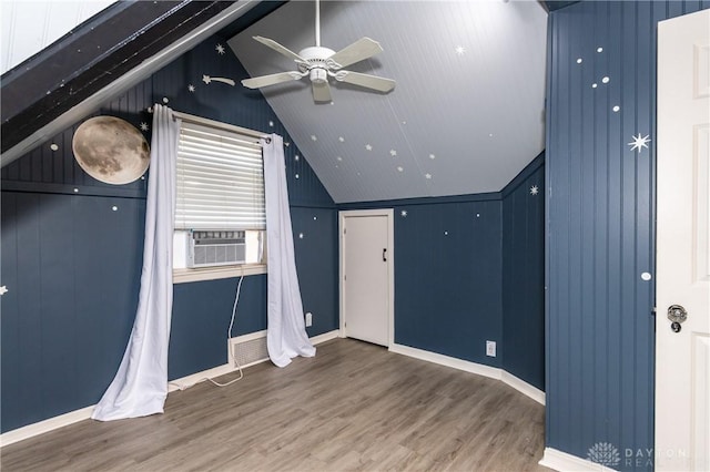 bonus room featuring ceiling fan, cooling unit, wood-type flooring, lofted ceiling, and wooden walls