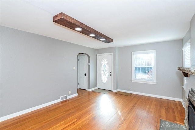 foyer featuring a fireplace and light hardwood / wood-style flooring