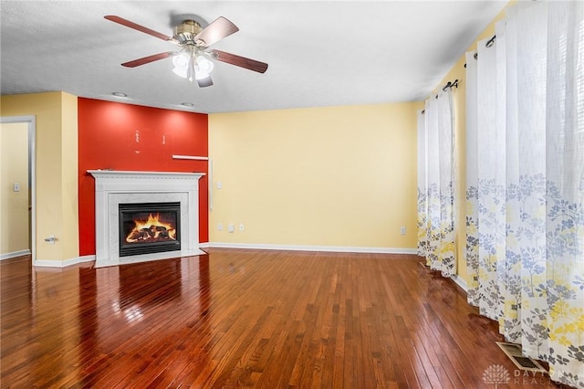 unfurnished living room with hardwood / wood-style flooring and ceiling fan