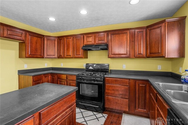 kitchen featuring sink, black appliances, a textured ceiling, and light hardwood / wood-style floors