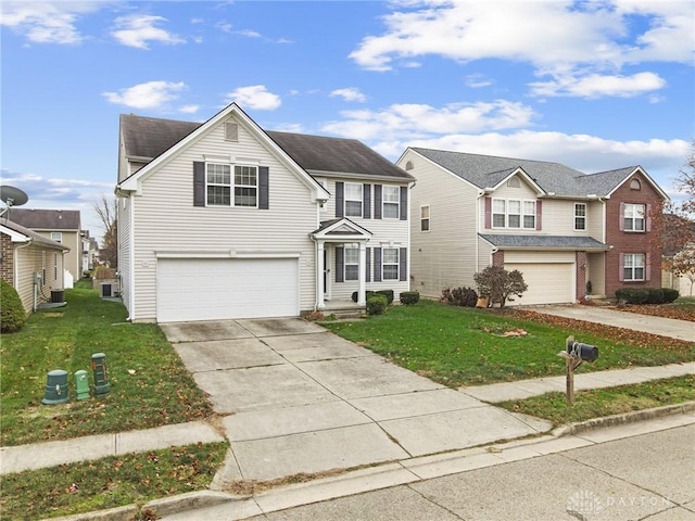 view of property featuring a garage and a front lawn