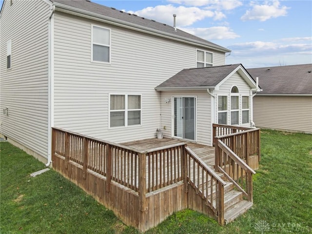 back of property featuring a lawn and a deck