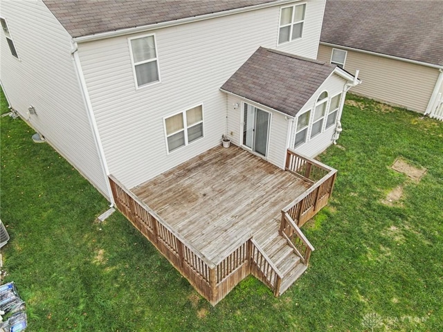 rear view of property featuring a yard and a wooden deck