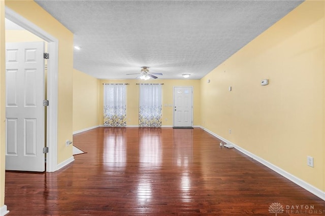 spare room with ceiling fan, wood-type flooring, and a textured ceiling