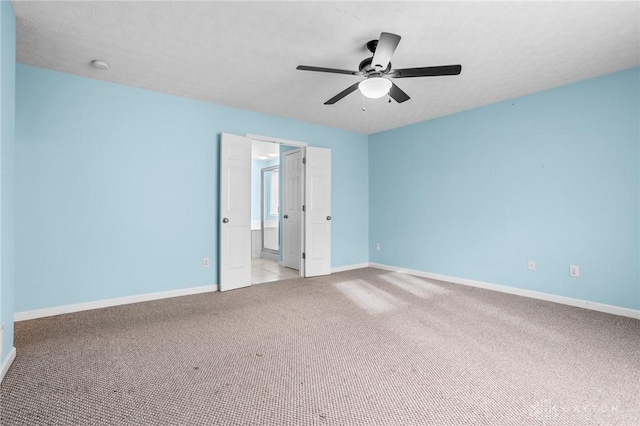 unfurnished bedroom featuring ceiling fan, light carpet, and a textured ceiling