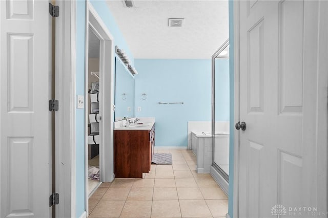 bathroom with separate shower and tub, tile patterned flooring, vanity, and a textured ceiling