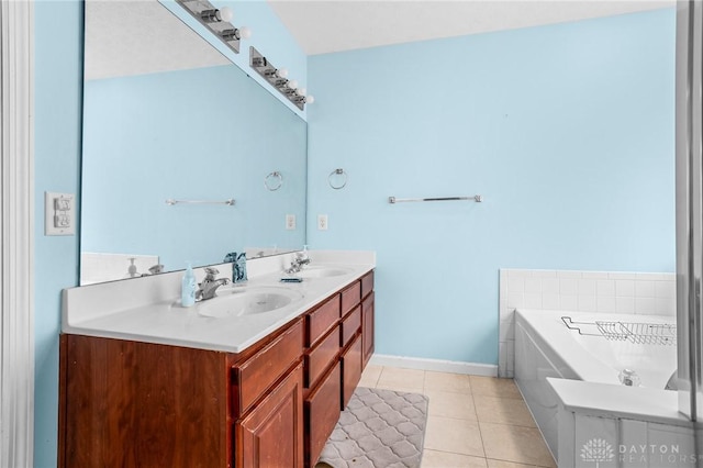 bathroom featuring tile patterned flooring, vanity, and a tub