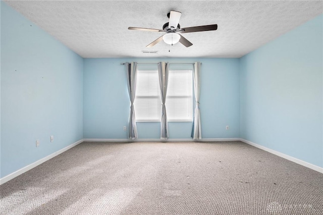 empty room featuring a textured ceiling, carpet floors, and ceiling fan