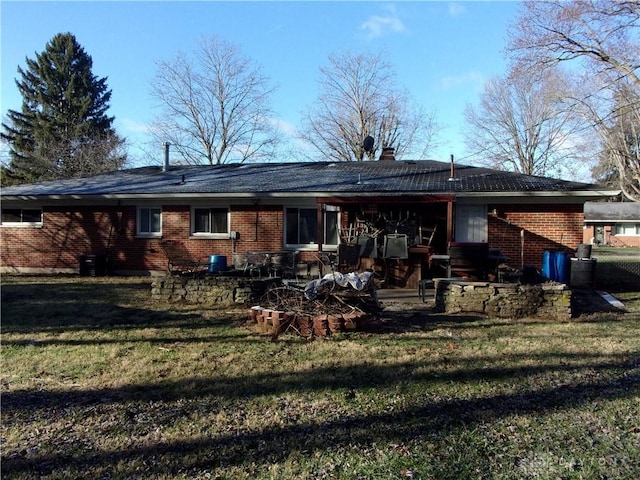 rear view of property with a yard