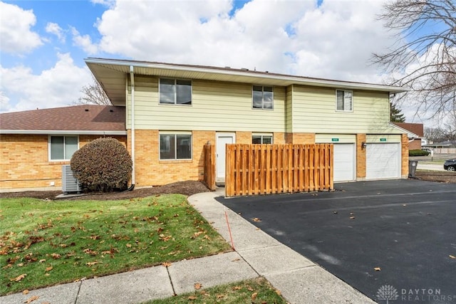 view of property with a front lawn and a garage