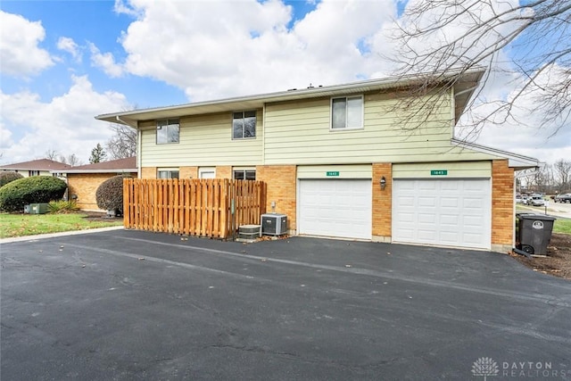 exterior space with central AC and a garage