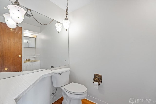 bathroom featuring toilet and wood-type flooring